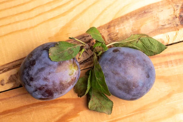 Two Organic Black Plums Close Wooden Table Top View — Stock Photo, Image
