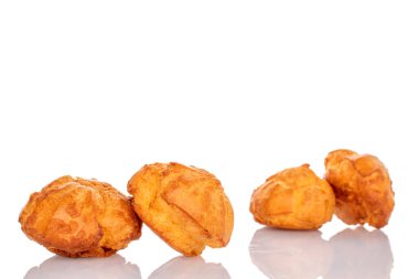 Several sweet chouquette, close-up, isolated on white.