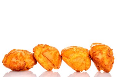 Several sweet chouquette, close-up, isolated on white.