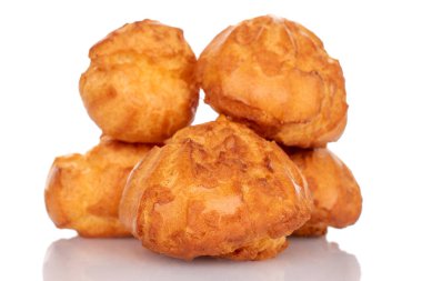 Several sweet chouquette, close-up, isolated on white.