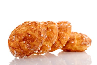 Several sweet chouquette, close-up, isolated on white.