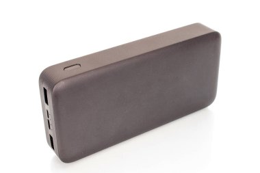 One black portable power bank charger close-up isolated on white background.