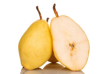 One whole and half ripe organic yellow pears, close-up, isolated on white.