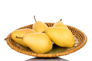 Several ripe organic yellow pears on a ceramic dish, close-up isolated on white.