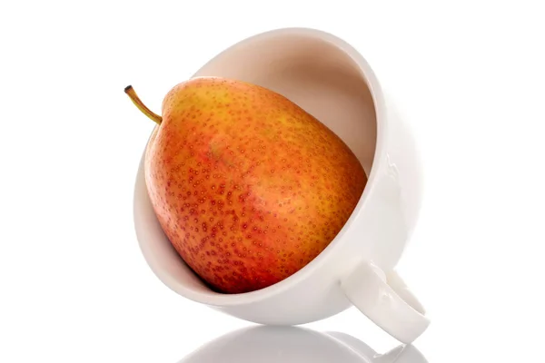 stock image One yellow-red pear with a white cup, close-up, on a white background.