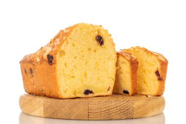 Tahta tepside beyaz arka planda izole edilmiş, dilimlenmiş ev yapımı kuru üzümlü kek..