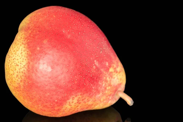 One ripe organic pear, macro, on a black background.