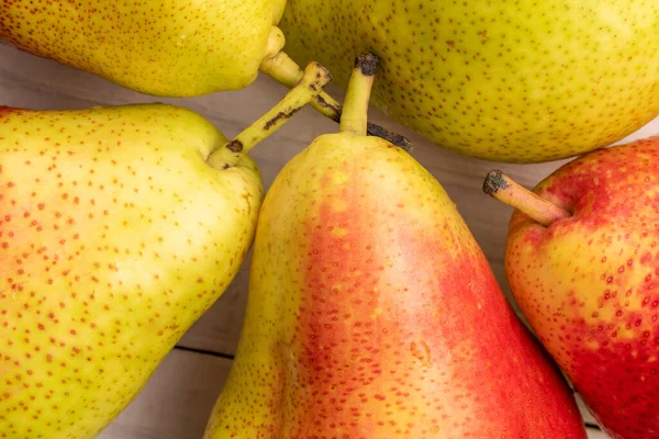 stock image Several organic sweet pears, close-up, on a white wooden table, top view.