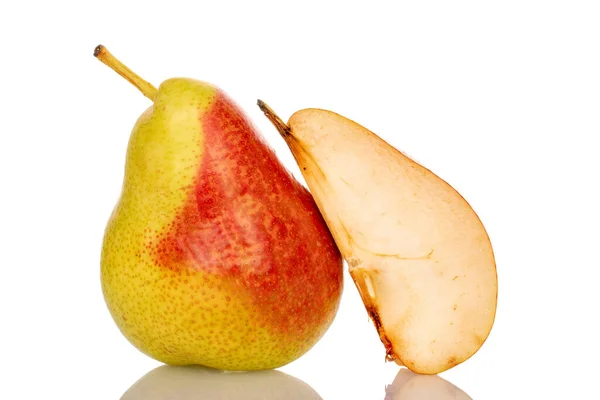 stock image One whole and a slice of juicy organic pear, close-up, on a white background.