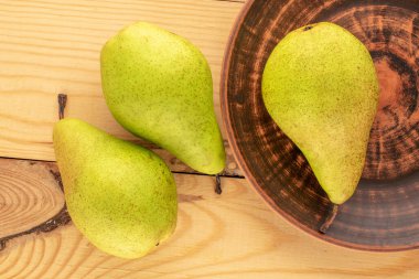 Tahta masada seramik plakalı üç organik armut, makro, üst manzara..