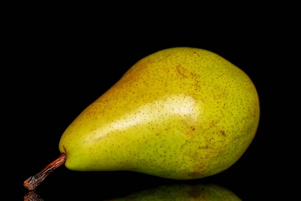 One ripe organic pear, macro, on a black background.