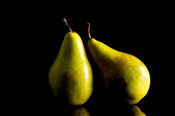 stock image Two ripe organic pears, macro, on a black background.