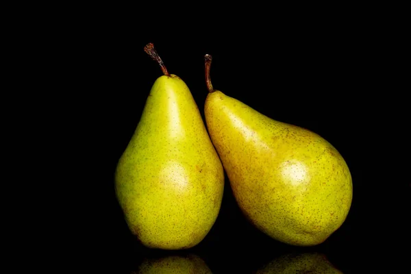Two ripe organic pears, macro, on a black background.