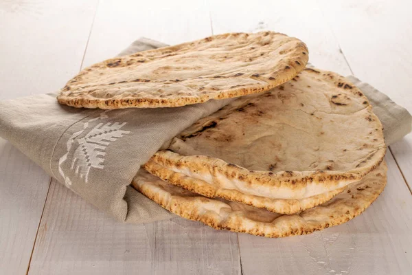 Several Freshly Baked Pita Bread Linen Napkin Close Wooden Table — Stock Photo, Image