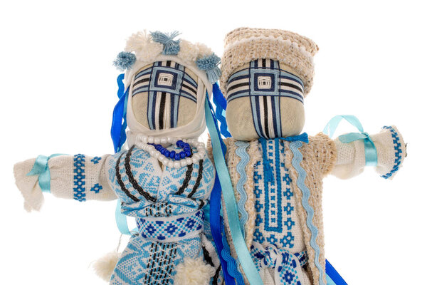 Ukrainian folk doll-motanka, macro, isolated on a white background.