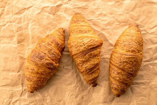 Three Delicious Croissants Chocolate Filling Craft Paper Close Top View — Stock Photo, Image