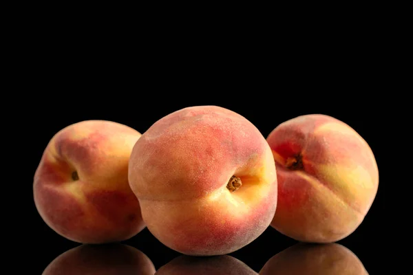 Three sweet juicy peaches, macro, isolated on white background.