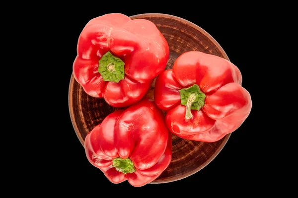Three Red Sweet Peppers Clay Plate Black Background Macro Top — Stock Photo, Image