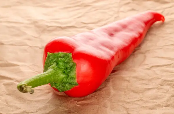 One red sweet pepper with on kraft paper