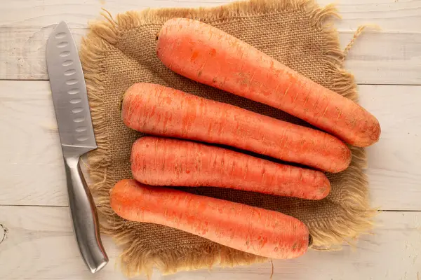 Several Ripe Carrots Jute Napkin Knife Wooden Table Macro Top — Stock Photo, Image