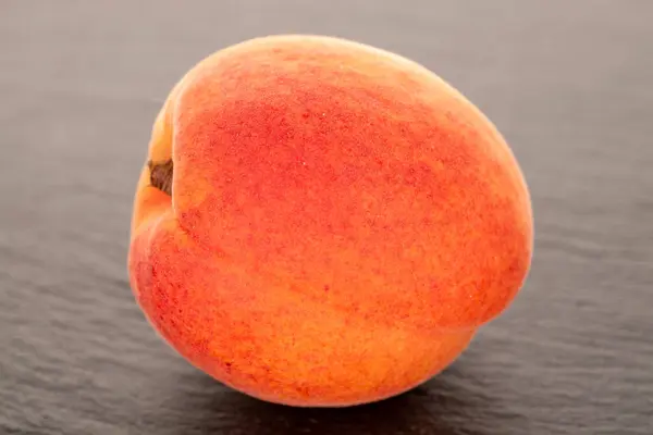 Stock image One juicy apricot  on slate stone, macro.