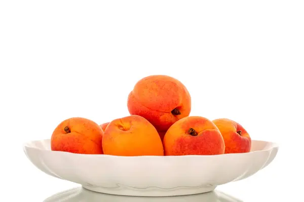 stock image Several juicy apricots with white ceramic plate isolated on white background, macro.