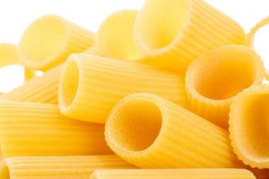 Raw durum wheat cannelloni pasta, macro isolated on white background.