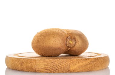 One ripe juicy kiwi on a wooden tray, macro, isolated on white background. clipart