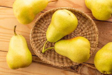 Tahta bir masada sulu sarı armutlar, üst manzara, makro.