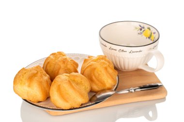 Beyaz arka planda izole edilmiş, seramik bir tabağın üzerinde birkaç eklem ve bir fincan kahve..