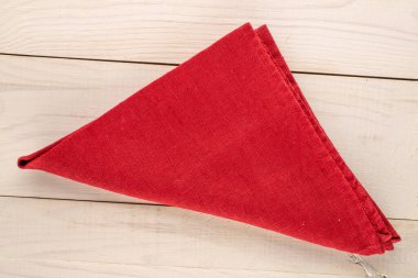 Ahşap bir masada kırmızı keten peçete, üst manzara, yakın çekim..