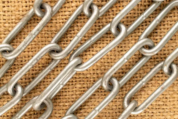 Jüt kumaş üzerine metal bir zincir parçası, makro, üst manzara..