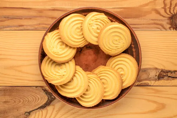 Ahşap bir masanın üzerinde mutfak aletleri olan kurabiyeler, yakın plan, üst manzara..