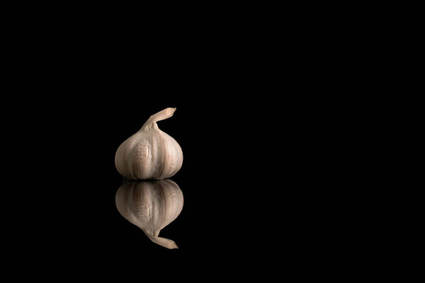 Чеснок головы изолированы на белом и черном фоне, крупным планом.