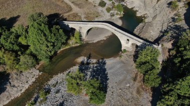 Old stone bridge of Aziz Aga, Venetikos river, aerial view, Grevena, Macedonia, Greece