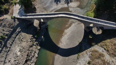 Old stone bridge of Aziz Aga, Venetikos river, aerial view, Grevena, Macedonia, Greece