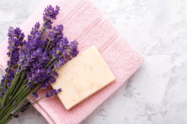 Hand made soap with lavender flowers on the grey stone background flat lay with copy space