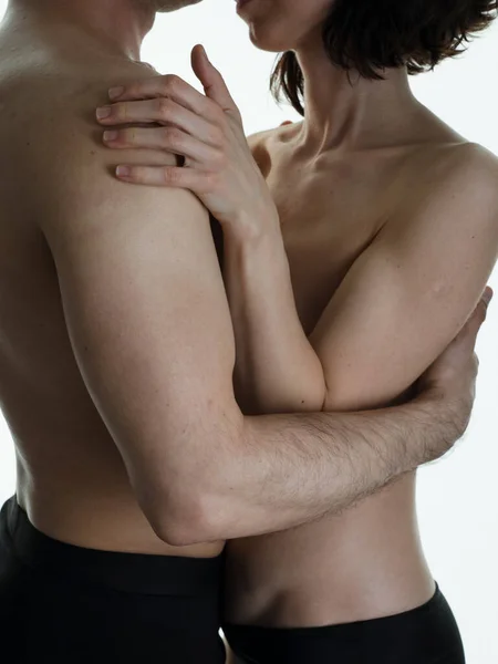 stock image Beautiful passionate naked couple in love. A man and a woman in each other's arms. Photo on a white background.