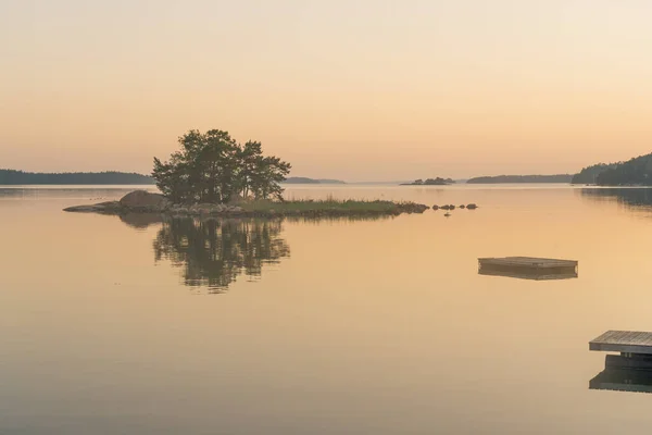 夕阳西下 海面上的天空 地平线上方的一棵树线和湖心的一个小岛的轮廓 芬兰的性质 斯堪的纳维亚半岛自然背景 案文的篇幅 — 图库照片