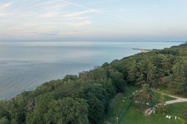 Toila, Estonia - 10.08.2022: Top view of Narva Bay on a summer evening. Toila Oru Park. The sky is a pastel color. The rich greenery of the park. Space for text. Natural background.