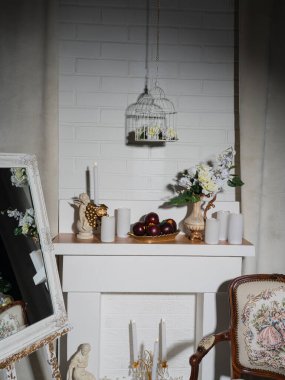 Old style room interior by fireplace with vintage armchair