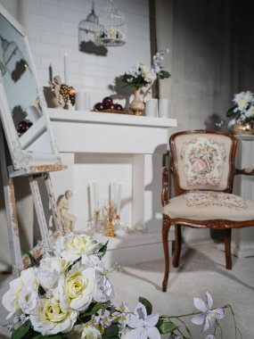 Old style room interior by fireplace with vintage armchair
