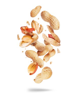 Whole and crushed peanuts close-up in the air on a white background clipart