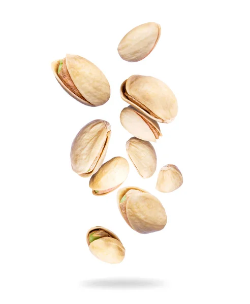 stock image Dried pistachios close-up in the air isolated on a white background 