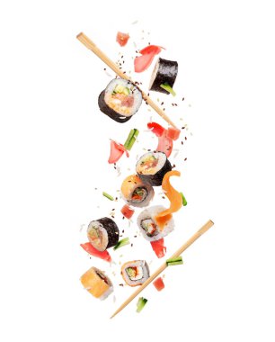 Fresh sushi rolls with various ingredients are falling down clipart