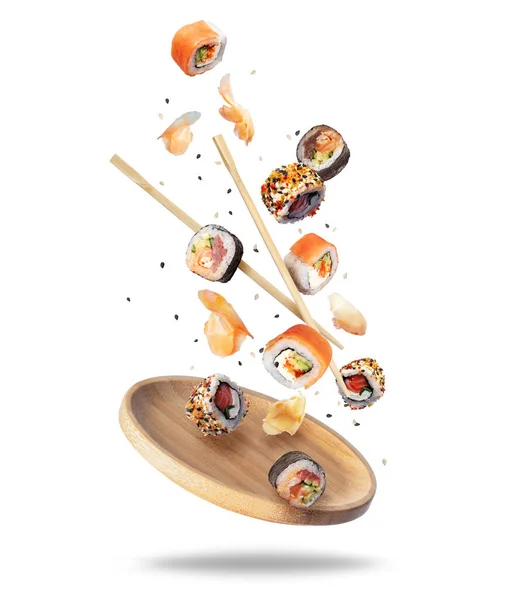 Různé Čerstvé Sushi Rolky Zázvorem Padající Dřevěnou Desku — Stock fotografie