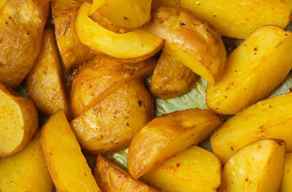 stock image Background with slices of cooking fried potatoes in oil on a baking sheet