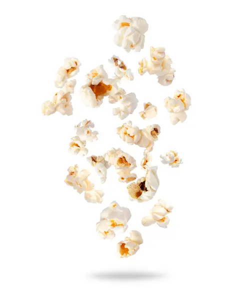 stock image Fluffy popcorn scattered in the air closeup on a white background. Randomly falling popcorn