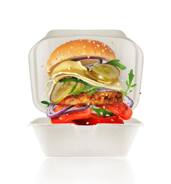 Delicious hot burger with ingredients in a cardboard box isolated on a white background