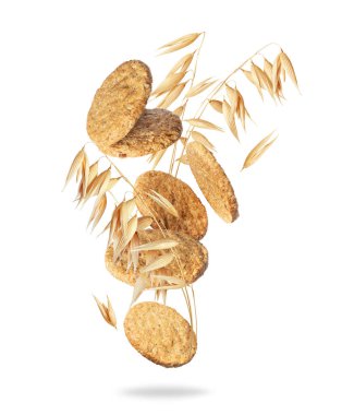 Havada kuru yulaf bitkisi olan yulaflı kurabiyeler beyaz arka planda izole edilmiş.
